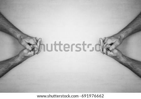 hands of a man are folded into a lock on a gray background, top view. black and white photo. mock up for text, phrases, lettering
