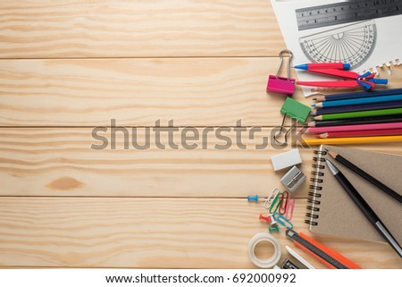 Office tools and stationery supplies on wooden table.Top view, space for text.