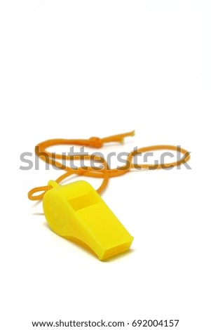 Yellow whistle on white backdrop