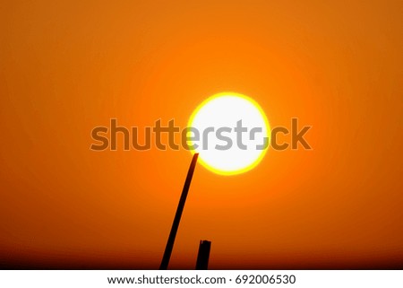 Silhouette Sunset With Yellow Sky And Wooden Pole