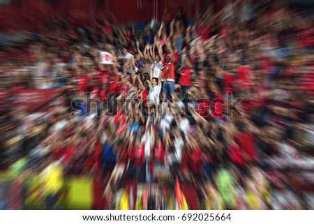 Blurred picture, people are cheer football in stadium.