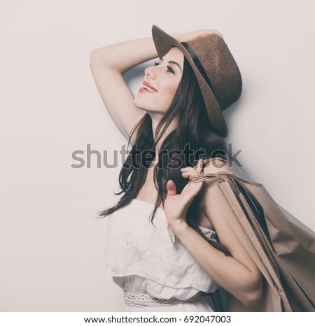 portrait of the beautiful young woman with shopping bags 
