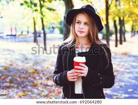 Happy teen girl walking on autumn park. Happy relax time in city. Beautiful woman, sunny day. Toning picture