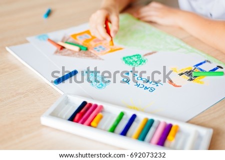Child drawing picture of boy going to school. Back to school