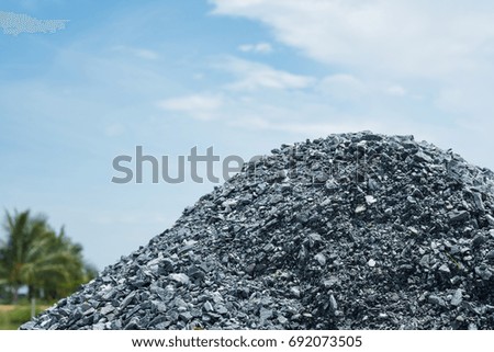 Pile of gravel gray stone prepare for mix concrete in construction with blue sky. material.
