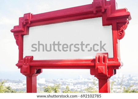 Blank red sign on hill of city