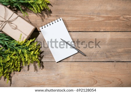 Present box on wooden table. Flat lay with copy space. Celebration, holiday season and winter concept