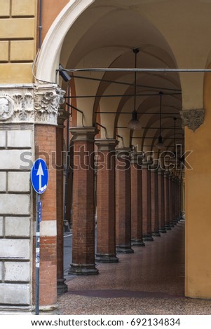 Gallery with orange columns on the street in Bologna, Italy in the day