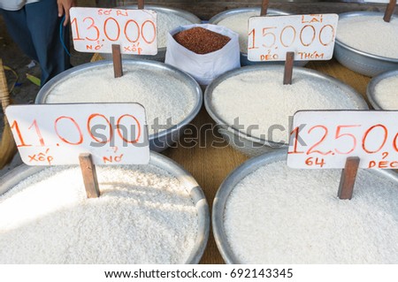 Many kind of rices tagging price per kilogram in Vietnam Dong selling at a vendor shop