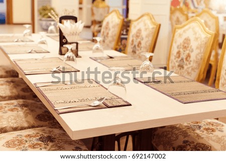 Rich dining room with wonderful dining table set.Golden bright yellow luxury dining room with elegant classic furniture.Beautiful Modern dining room interior .
