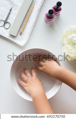 two little girl hands in the water Royalty-Free Stock Photo #692170750