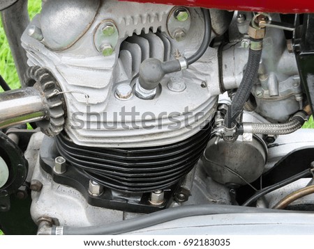 engine of vintage british motorcycle showing cylinders and spark plugs