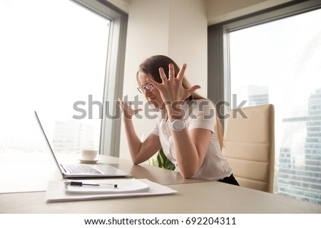 Angry annoyed businesswoman having problem with computer, mad woman indignant about broken laptop failure, lost important data after critical fatal error, pc crash message, unsaved information loss Royalty-Free Stock Photo #692204311