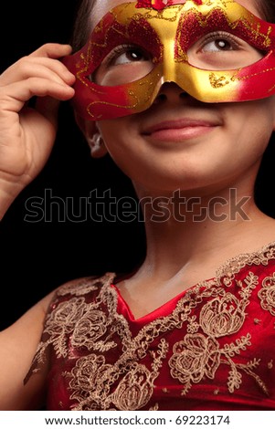 Portrait on a lovely girl wearing a  red mask. See other images.