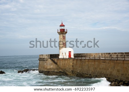 Porto Pi­ Lighthouse - Old Porto's lighthouse and harbor waves.
