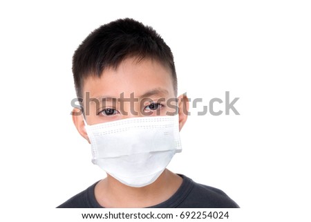 Boy wearing mask for protect disease because he get infection flu, Unwell child with sadness face Isolated on white background Royalty-Free Stock Photo #692254024