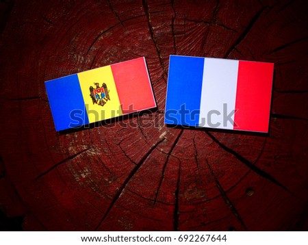 Moldovan flag with French flag on a tree stump isolated