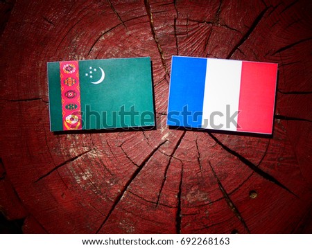 Turkmenistan flag with French flag on a tree stump isolated