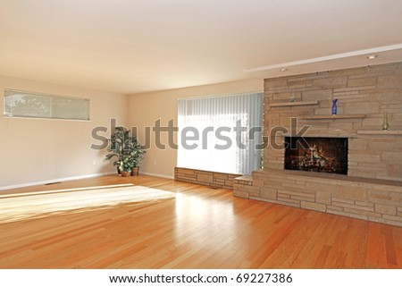 Large empty living room with stone fireplace in asian style