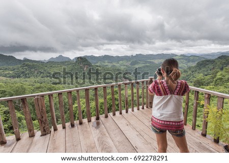 Young traveler woman take a photo of beautiful of  mountain view,pai,Thailand