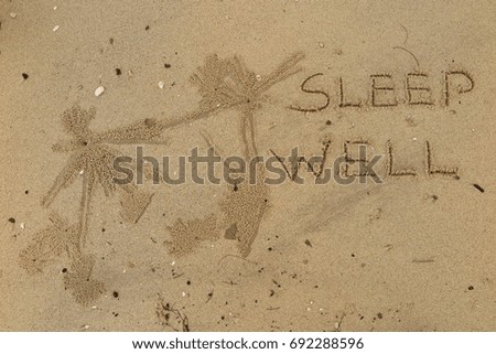 Handwriting  words "SLEEP WELL." on sand of beach.