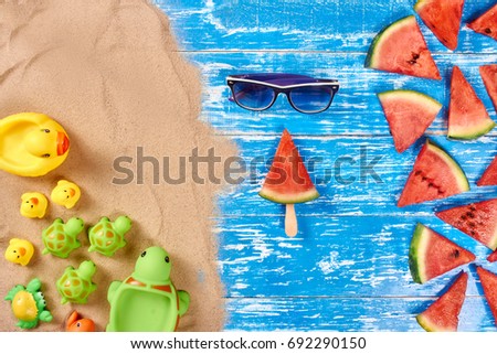 Summer background with watermelon slices, sunglasses, sand, Yellow rubber ducks, Green turtles