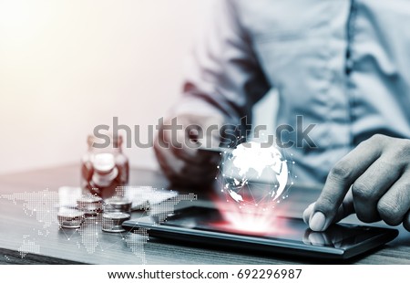 Technology network online banking and internet banking and networking people concept, Business man with laptop and coin saving money in business office Royalty-Free Stock Photo #692296987