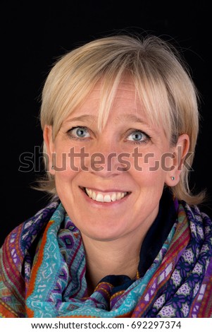 beautiful caucasian mature woman wearing colorful shawl  - photograph on black background