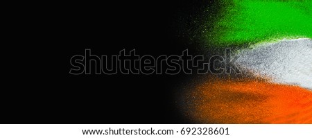 Indian Republic Day celebration background banner. Red, green and saffron color powders splashed over dark background.  Royalty-Free Stock Photo #692328601