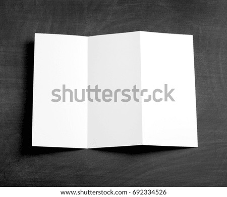 Blank folding page booklet on a black chalkboard