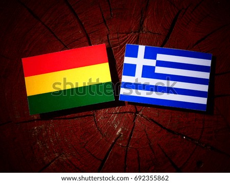 Benin flag with Greek flag on a tree stump isolated