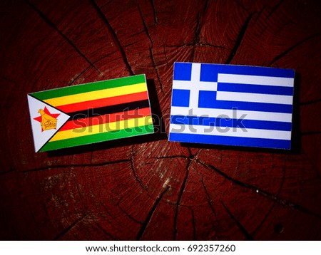 Zimbabwe flag with Greek flag on a tree stump isolated