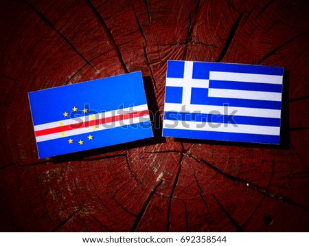 Cape Verde flag with Greek flag on a tree stump isolated
