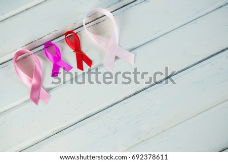 High angle view of Cancer Awareness ribbons on white wooden table