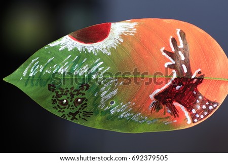 deer and tiger painting on green leaf on red light and black background Royalty-Free Stock Photo #692379505