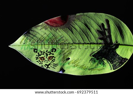 deer and tiger painting on green leaf and black background Royalty-Free Stock Photo #692379511