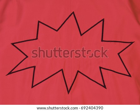 Red denim background with cartoon balloon boom embroidery with empty space for copy