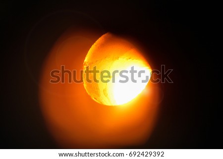 Macro picture of melting furnace on a black background. Production of aluminum. Aluminum foundry. Orange bright molten steel. 