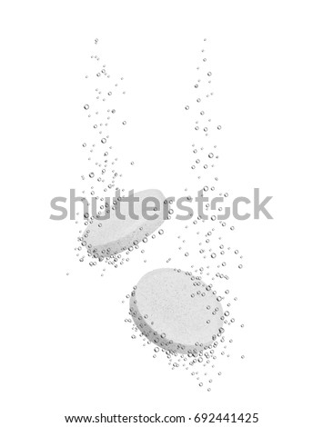 Medical pills dissolves in water on white background 