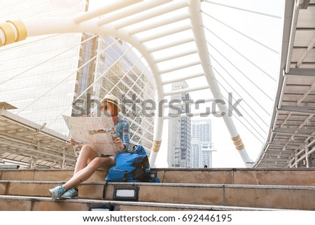 Woman westerner looking at map during city tour in the morning, planning for today's trip