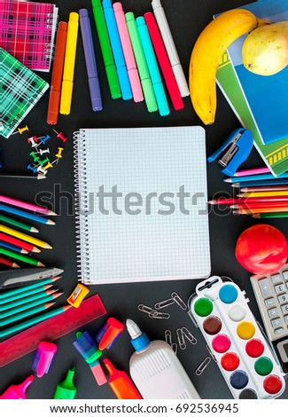 Back to school concept.School and office supplies on black background. Flat lay with copy space Royalty-Free Stock Photo #692536945