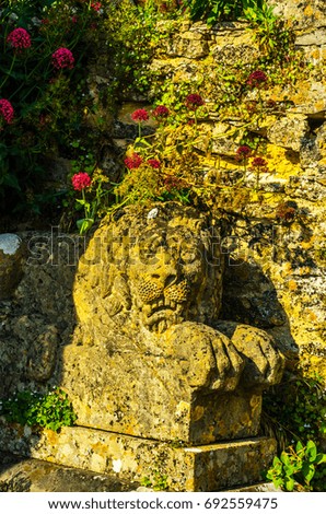 Old sculpture on the pedestal, beautifully preserved old artistic figure, decorative elements on the outside, vintage