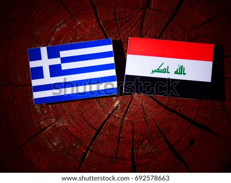 Greek flag with Iraqi flag on a tree stump isolated