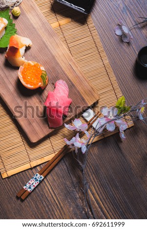 traditional Japanese cuisine. Process of eating sushi rolls or sushi set with salmon, selective focus