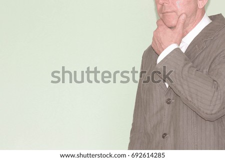 Business training concept. Photo for your design. The man holds a hand to his chin. Meditation.