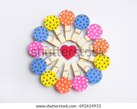 Color full wood clips look like ladybug in Flower arrangement with red heart in the middle on white background