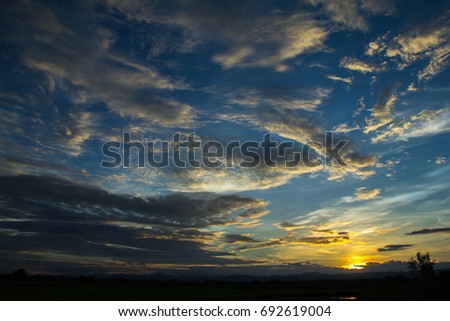 Dramatic sunset sky with clouds.