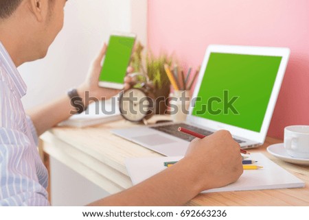 Businessman use computer laptop and use telephone for work, green screen.