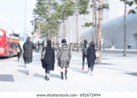 Abstract blurred background of street people or traveler walking on pedestrian and cars on the road in the city of Seoul Korea