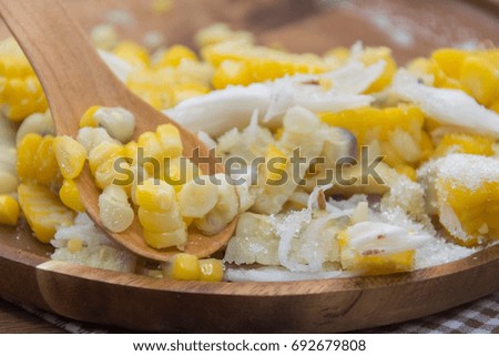 Sweet Corn with coconut and sugar on wooden plate